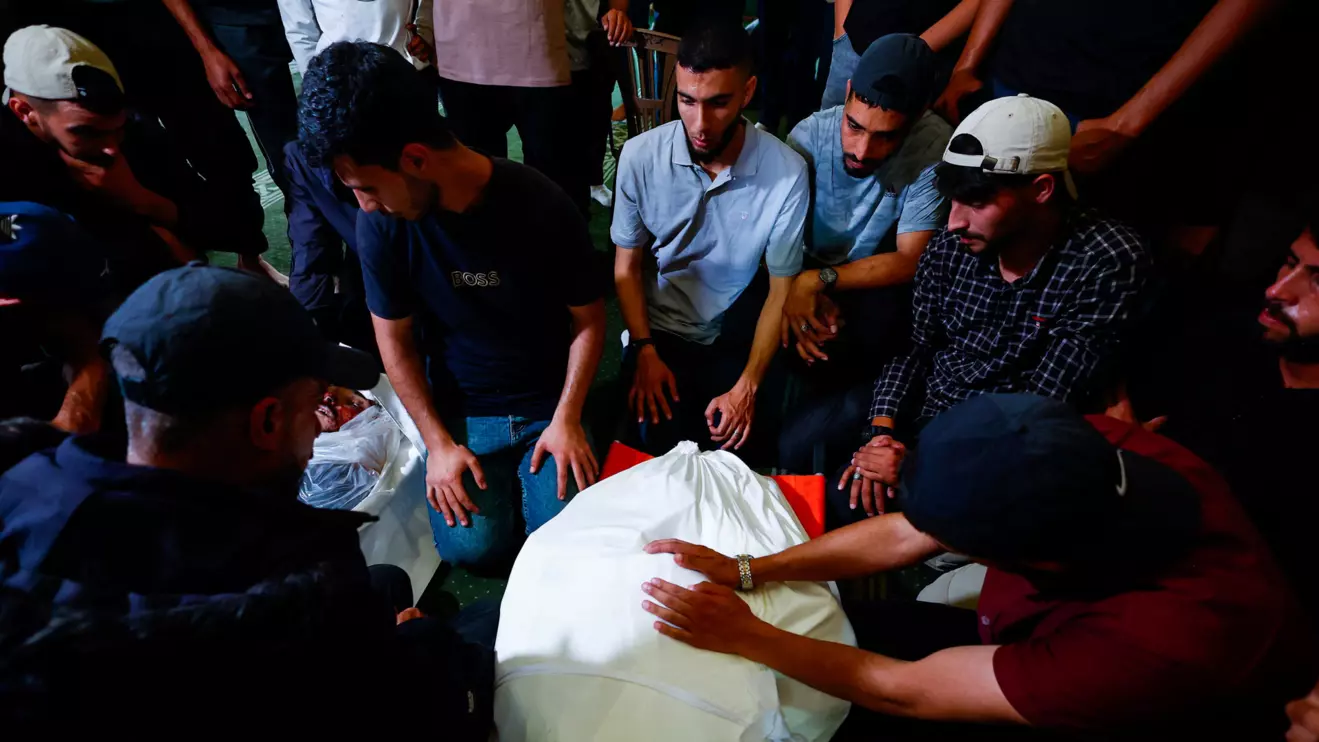 People mourn over a body identified by mourners as Hamas' military wing commander Mohammad Odeh who was killed in an Israeli strike on Tuesday, during a funeral, in Gaza City, May 27, 2026. Reuters/Mahmoud Issa