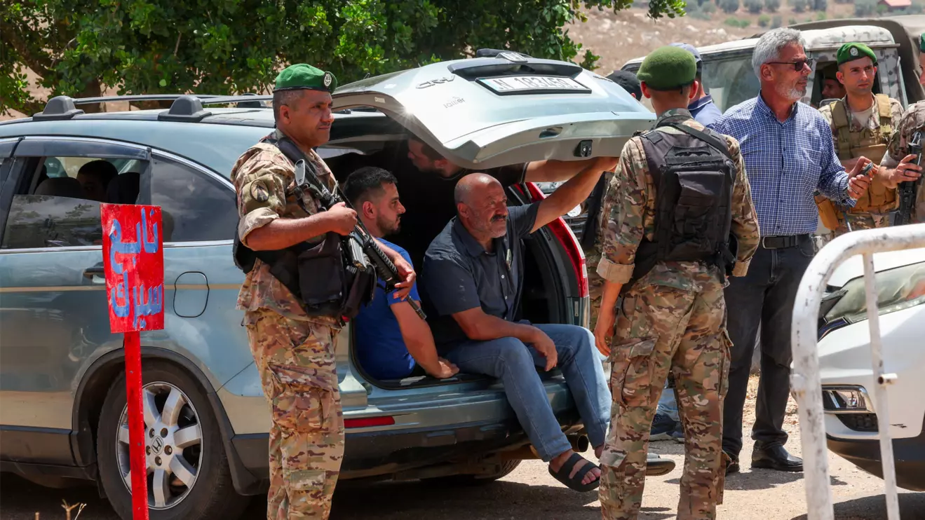 Lebanese soldiers inspect a vehicle as residents wait to enter the town of Zawtar al-Gharbiyeh, following the withdrawal of Israeli forces under a U.S.-brokered plan, in southern Lebanon, July 24, 2026. Reuters/Aziz Taher