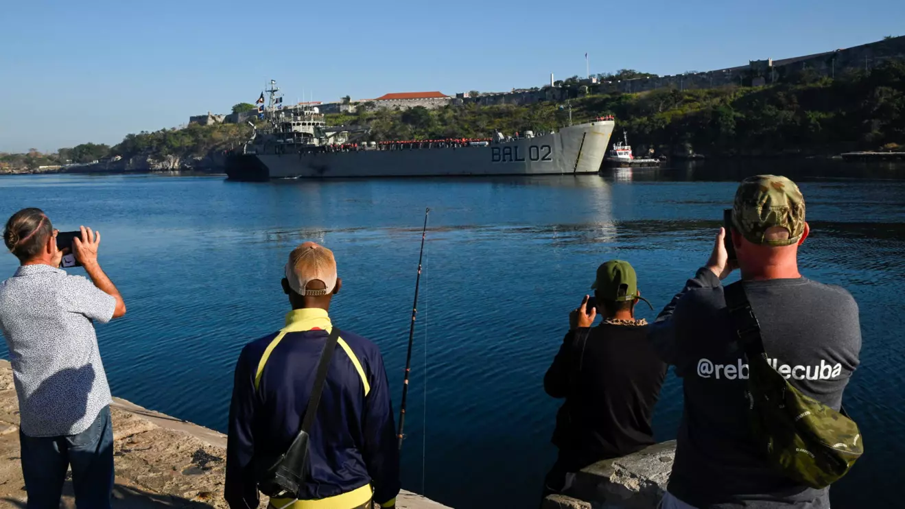 People take pictures of Mexican-flagged ship loaded with humanitarian aid entering Havana's bay days after the island's communist-run government announced increasingly strict rationing measures to confront U.S. efforts to cut off the island’s fuel supply, Havana, Cuba February 12, 2026. Reuters/Norlys Perez