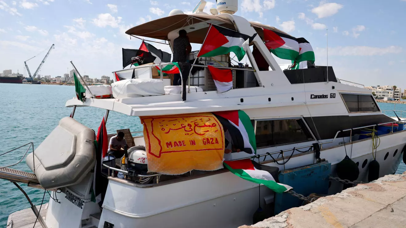 People gather on a boat from a flotilla that had been carrying aid to Gaza until it was intercepted by Israel, docked in the port of Larnaca, Cyprus October 3, 2025. Reuters/Yiannis Kourtoglou