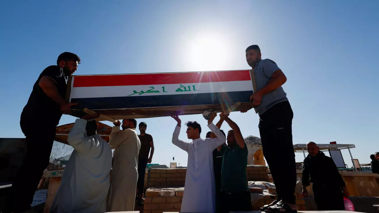 Men carry coffin of an Iraqi soldier at the Wadi al-Salam cemetery, Arabic for "Peace Valley", who was killed in an attack by Islamic State militants on an army post in a rural area between Diyala and Salahuddin provinces, during the funeral in Najaf, Iraq, May 14, 2024. Reuters/Alaa Al-Marjani
