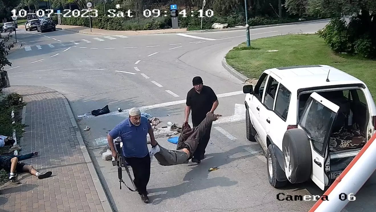 In the CCTV footage, a white SUV drives into Kibbutz Be'eri, one of the communities hardest hit on Oct. 7