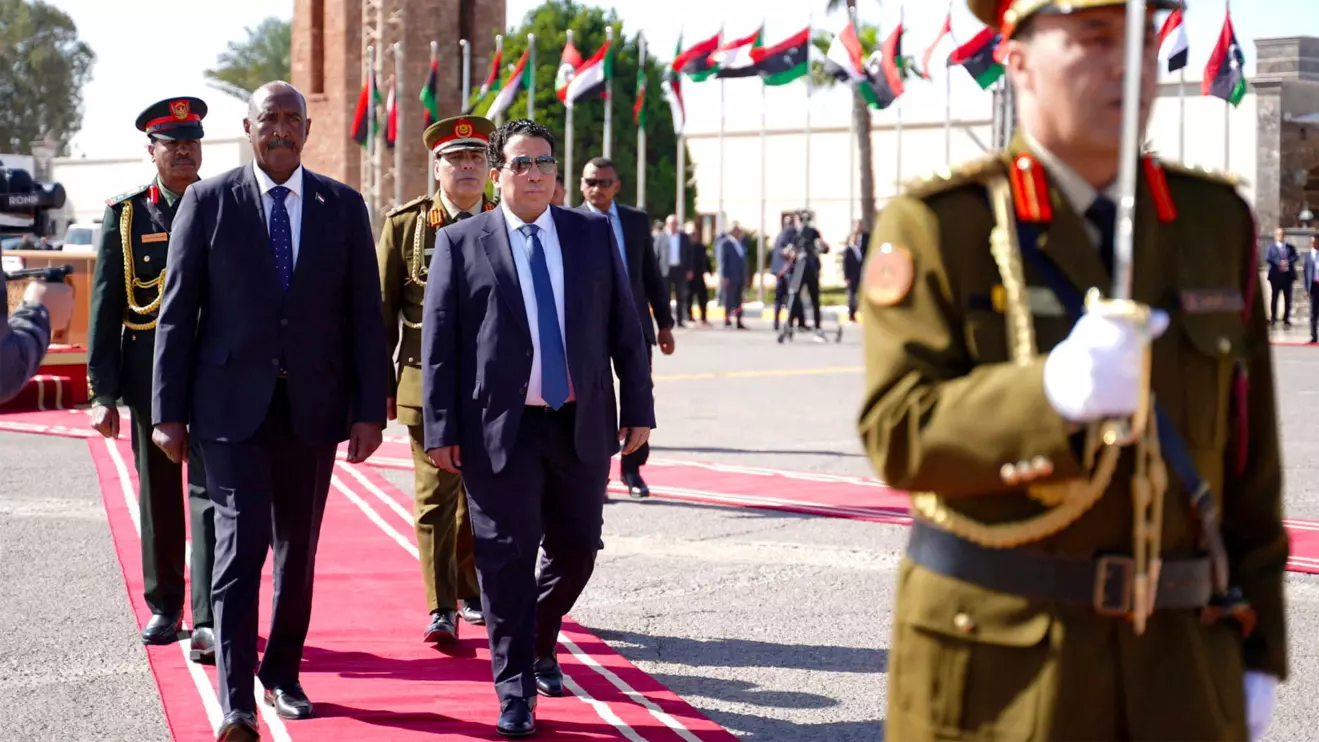 Head of the Libyan Presidential Council Mohamed al-Menfi meets Sudan's Sovereign Council Chief General Abdel Fattah Al-Burhan in Tripoli, Libya, February 26, 2024. Media Office of Libya's Government of National Unity/Handout via Reuters