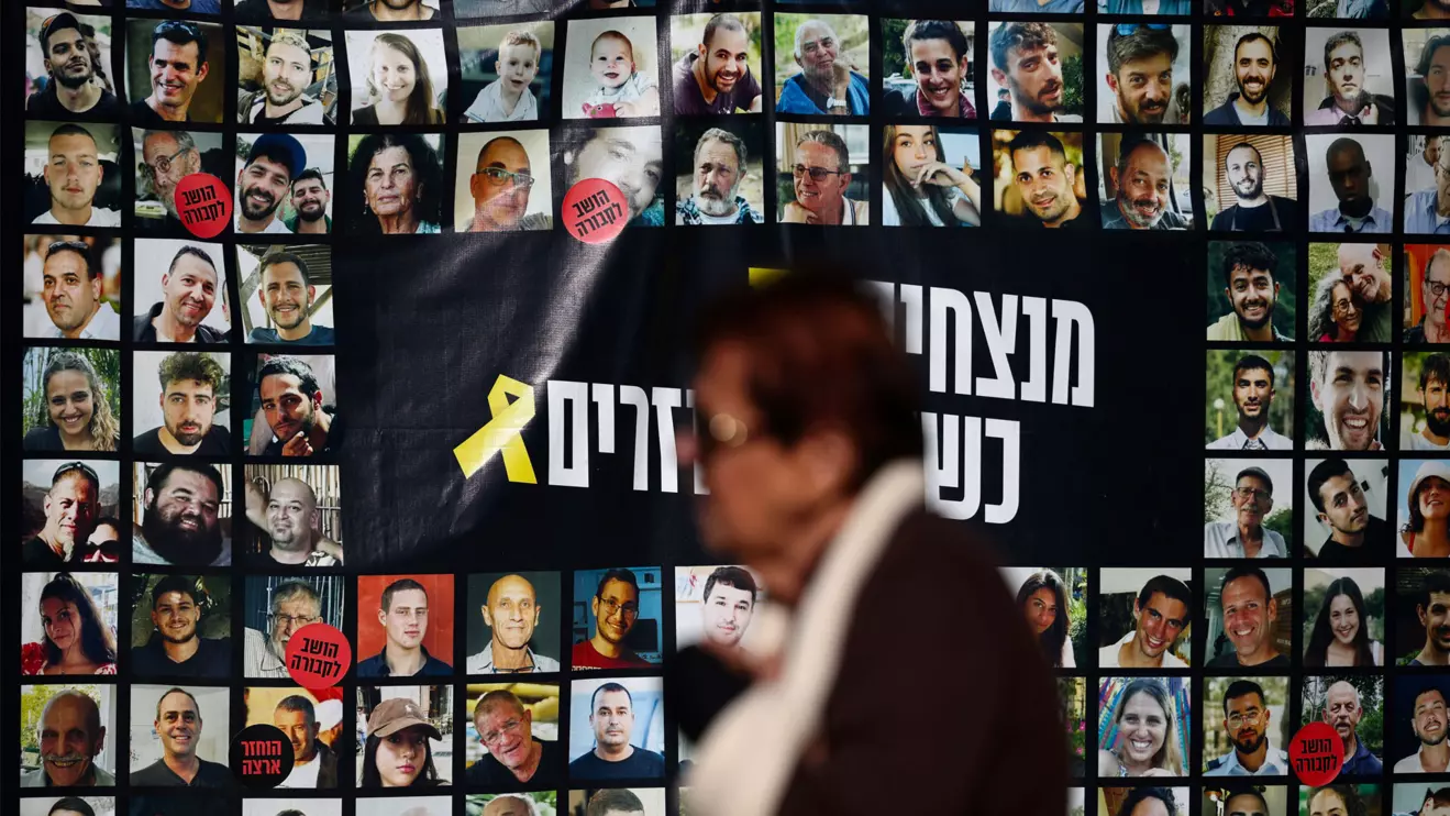 A woman walks past posters of hostages kidnapped during the deadly October 7, 2023 attack by Hamas, in Tel Aviv, Israel, December 16, 2024. Reuters/Stoyan Nenov