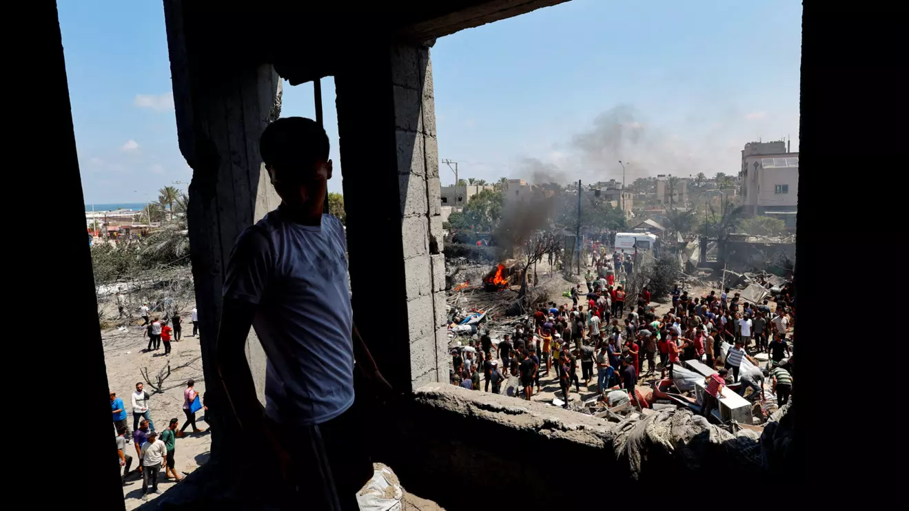 Palestinians gather near damages, following what Palestinians say was an Israeli strike at a tent camp in Al-Mawasi area, amid Israel-Hamas conflict, in Khan Younis in the southern Gaza Strip July 13, 2024. Reuters/Mohammed Salem