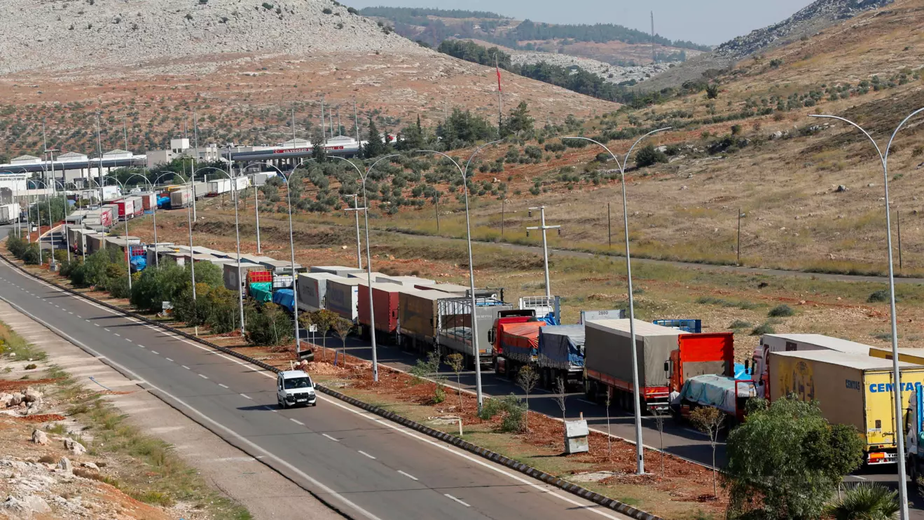 Turkish trucks transporting sacks of cement wait to cross to Syria near the Cilvegozu border gate which is located opposite of Syrian commercial crossing point Bab al-Hawa, in Hatay province, Reuters/Murad Sezer