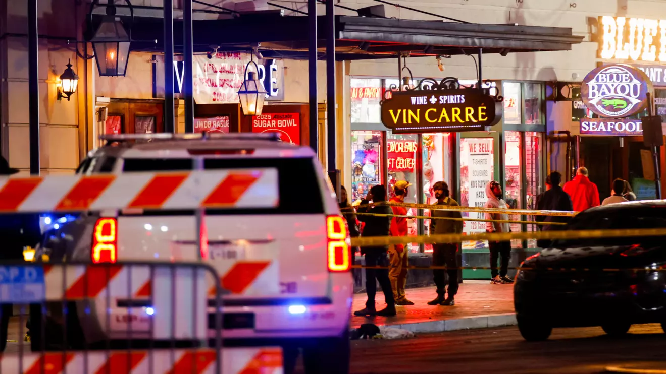 Law enforcement vehicles and people stand near the area near the scene where a vehicle drove into a crowd during New Year's celebrations, in New Orleans, Louisiana, U.S., January 1, 2025. Reuters/Eduardo Munoz