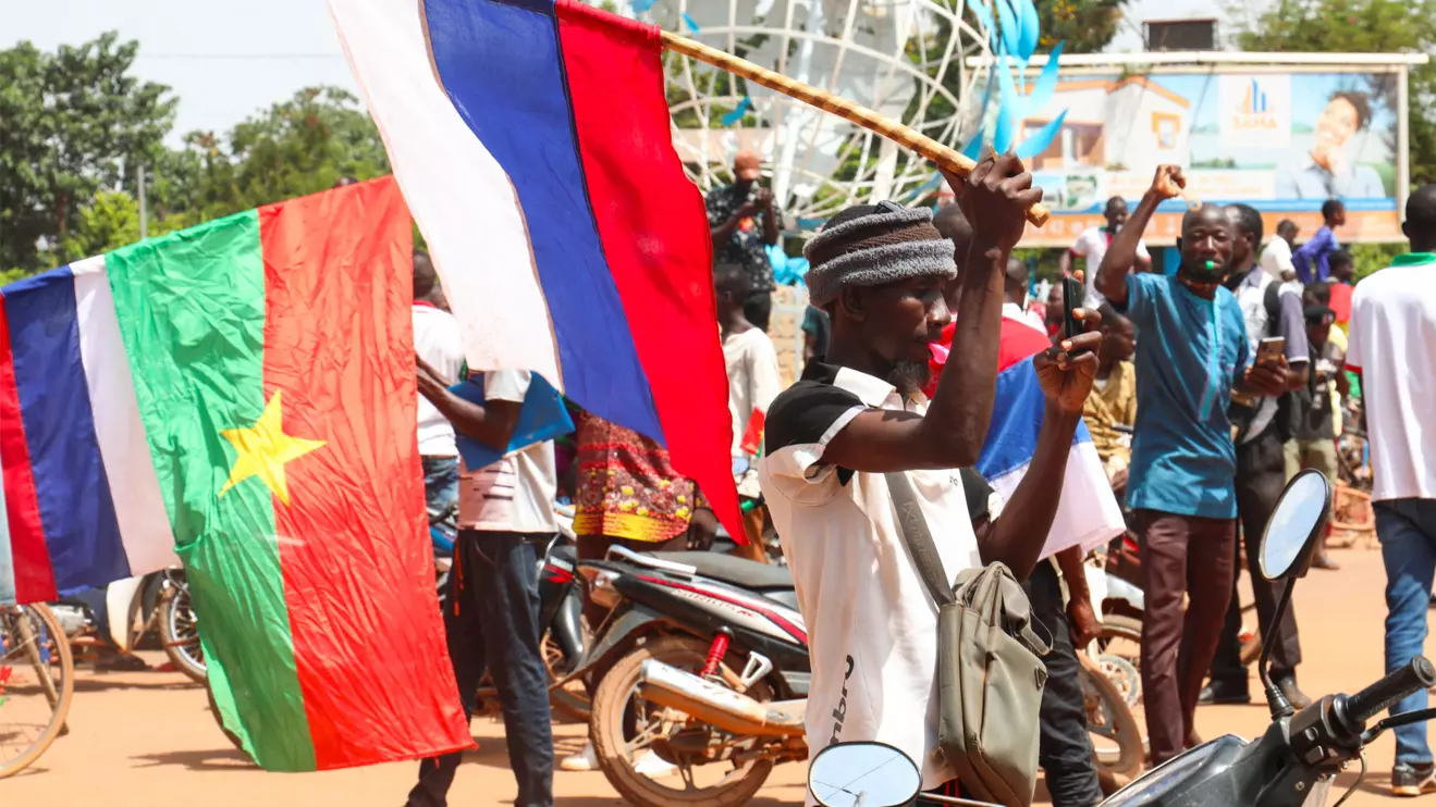 Supporters of Burkina Faso's new junta hold Burkina Faso and Russian flags as they gather to protest against the arrival of ECOWAS (Economic Community of West African States) delegation in Ouagadougou, Burkina Faso October 4, 2022. Reuters/Vincent Bado