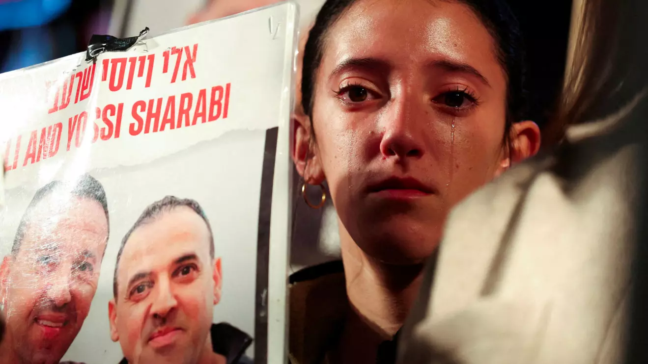 Ofir Sharabi, daughter of the late Yossi Sharabi and niece of Eli Sharabi, reacts as people gather in support of the Israeli hostages kidnapped during the deadly October 7 2023 attack by Hamas, the day before a ceasefire deal between Israel and Hamas is due to go into effect, in Tel Aviv, Israel, January 18, 2025. Reuters/Nir Elias