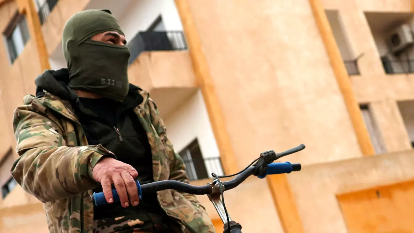 A fighter of the ruling Syrian body, who lost a finger during fighting, rides a bicycle at the official housing of the Fourth Division in the army under the Assad regime, following evacuation orders from factions of Hay'at Tahrir al-Sham (HTS), after Syria's Bashar al-Assad was ousted, on the outskirts of Damascus, in Syria, December 29, 2024. Reuters/Amr Abdallah Dalsh