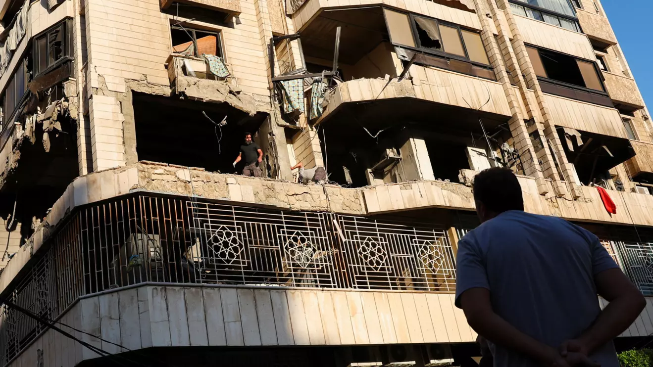 A man looks at a damaged building at the site of an Israeli strike on central Beirut's Bachoura neighbourhood, amid ongoing hostilities between Hezbollah and Israeli forces, in Beirut, Lebanon October 3, 2024. Reuters/Emilie Madi