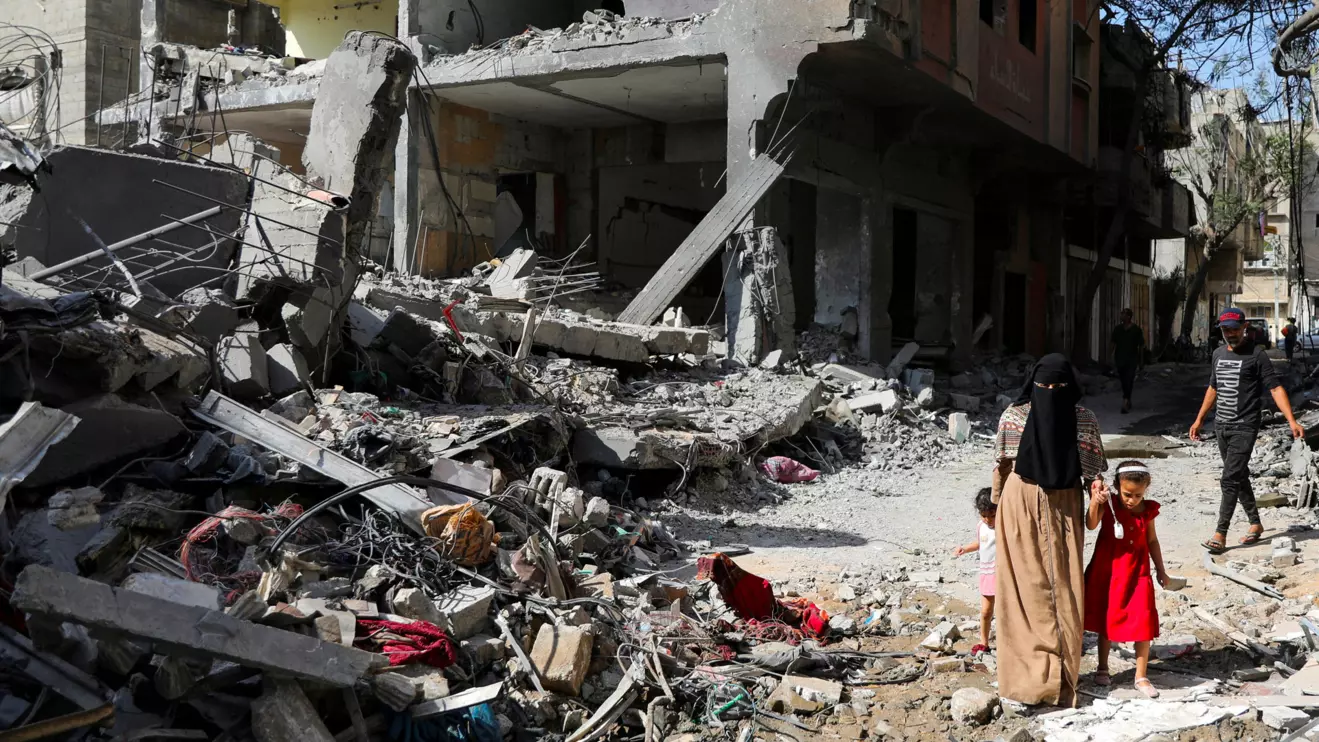 A woman and child walk among debris, aftermath of Israeli strikes at the area, where Israeli hostages were rescued on Saturday, as Palestinian death toll rises to 274, amid the Israel-Hamas conflict, in Nuseirat refugee camp in the central Gaza Strip, June 9, 2024. Reuters/Abed Khaled
