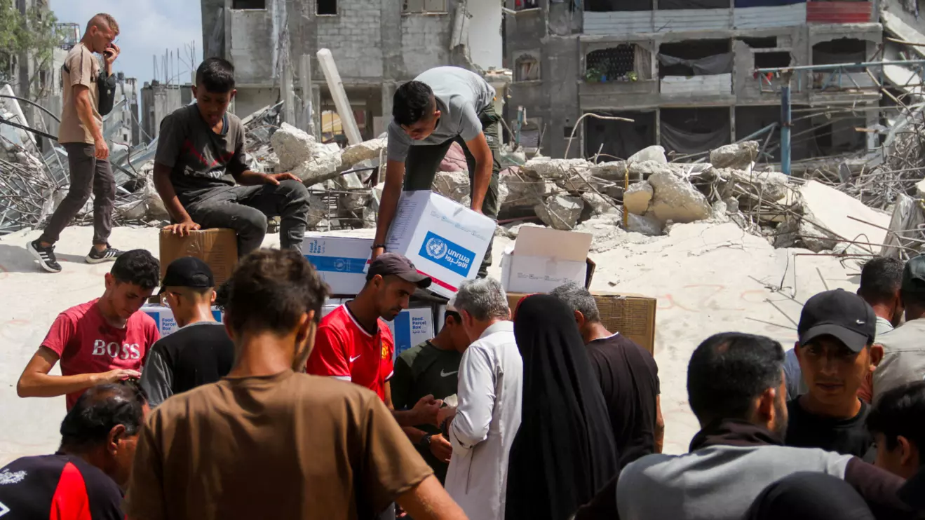 Palestinians gather to receive aid, including food supplies provided by World Food Program (WFP), outside a United Nations distribution center, amid the Israel-Hamas conflict, in Jabalia in the northern Gaza Strip, August 24, 2024. ReutersMahmoud Issa
