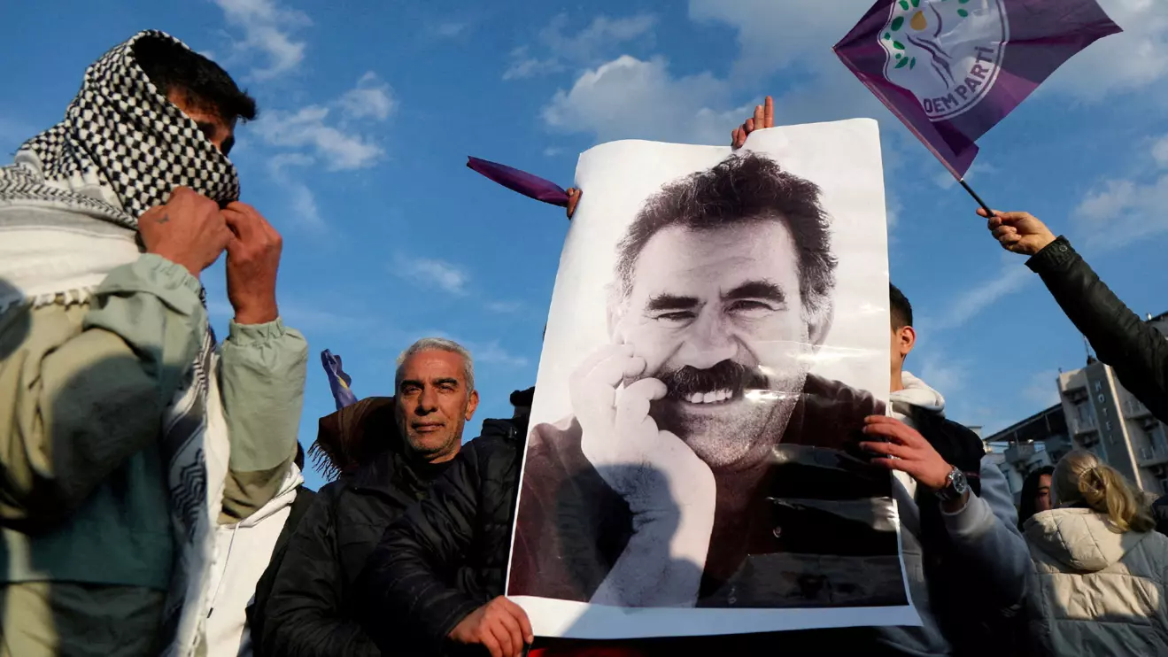 A demonstrator holds a picture of jailed Kurdish militant leader Abdullah Ocalan during a rally in Diyarbakir, Turkey, February 27, 2025. Reuters/Sertac Kayar
