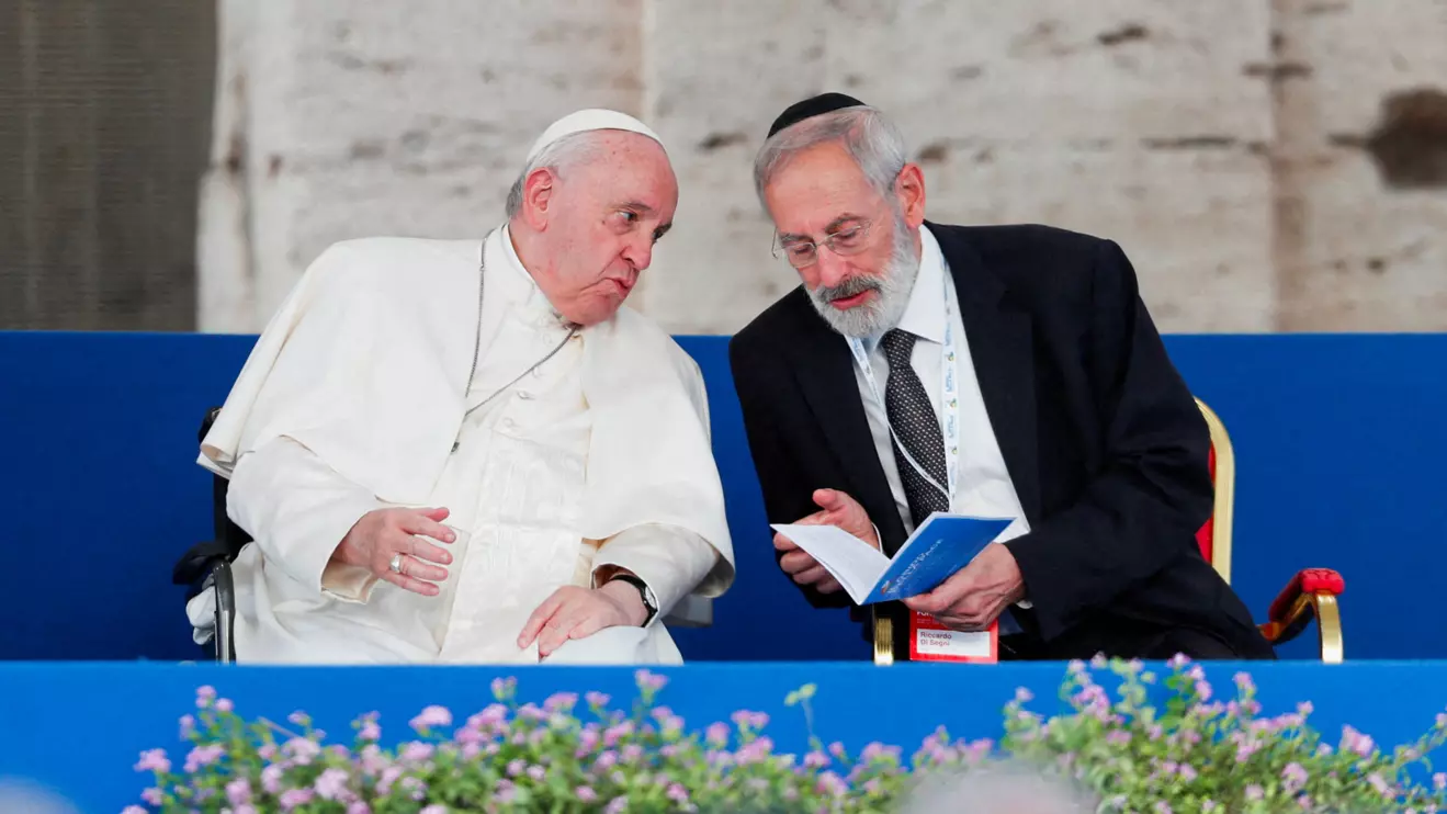 Rabbi Riccardo Di Segni speaks with Pope Francis during an inter-religious prayer for peace at the Colosseum in Rome, Italy, October 25, 2022. Reuters/Remo Casilli