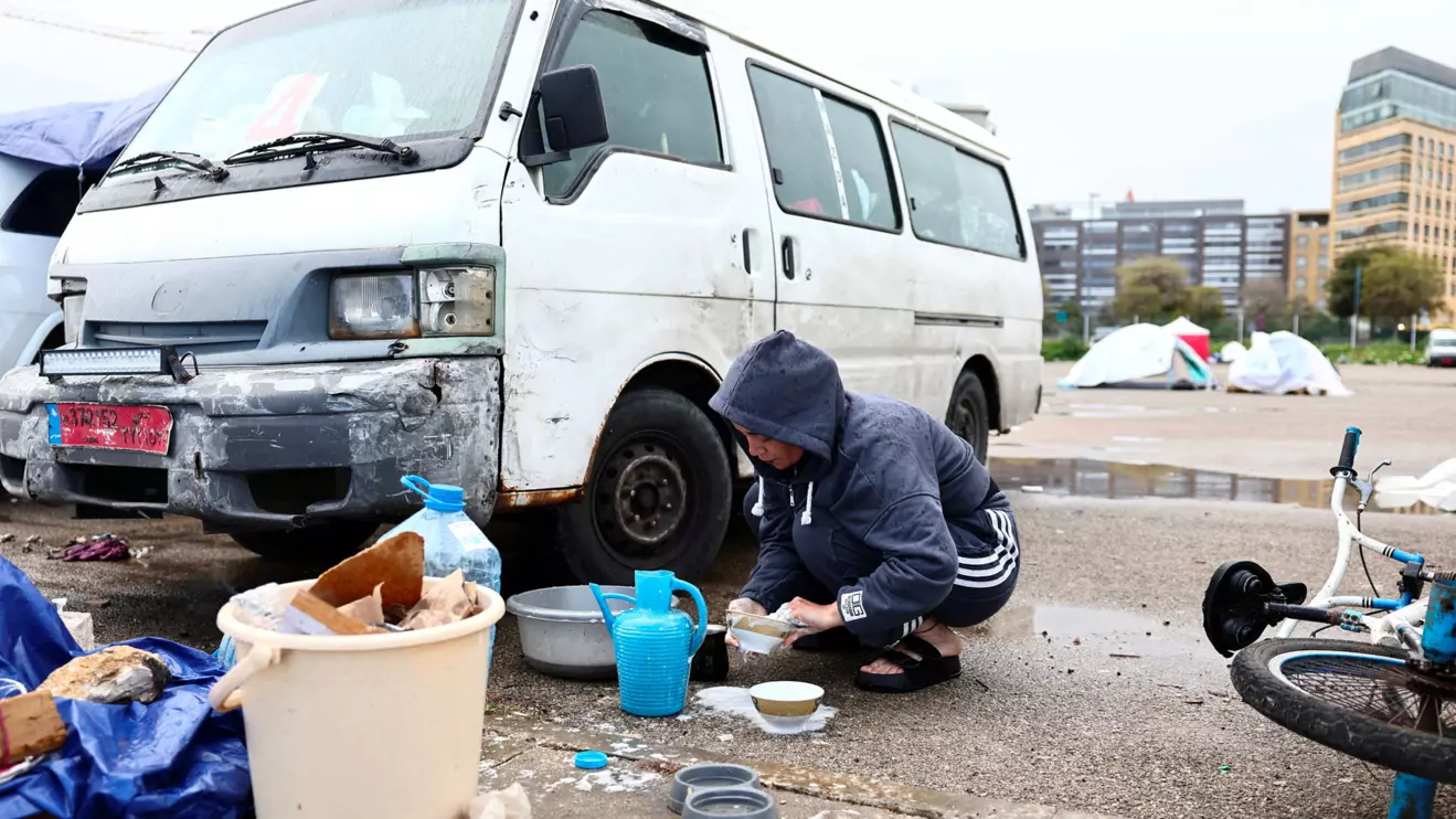 Samah Hjola, 33, displaced from Beirut's southern suburbs, washes items on the day Muslim worshippers attend Eid al-Fitr prayers to mark the end of the holy fasting month of Ramadan, following an escalation between Hezbollah and Israel amid the U.S.-Israeli conflict with Iran, in Beirut, Lebanon, March 20, 2026. Reuters/Yara Nardi