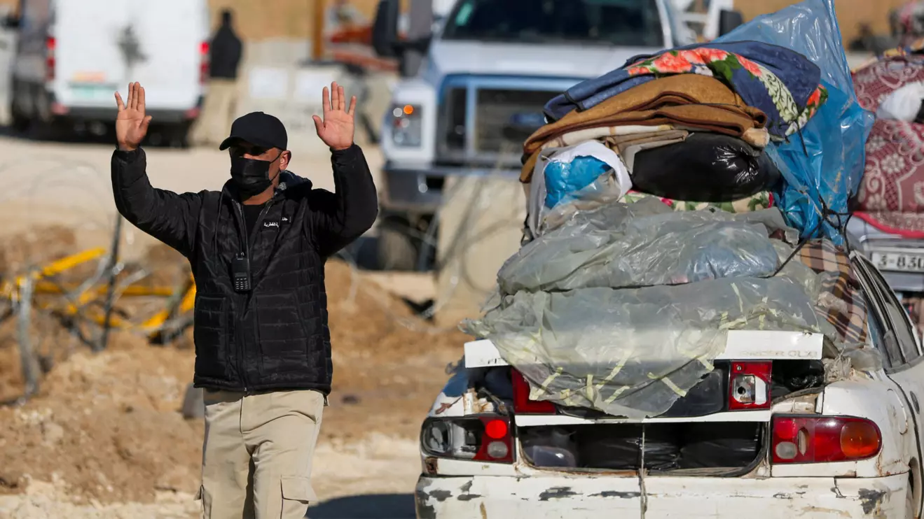 A member of the Egyptian-Qatari committee gestures while inspecting vehicles carrying Palestinians, displaced to the south by Israel’s order during the war, as they return to their homes in northern Gaza amid a ceasefire between Israel and Hamas, near Gaza City, January 27, 2025. Reuters/Hatem Khaled