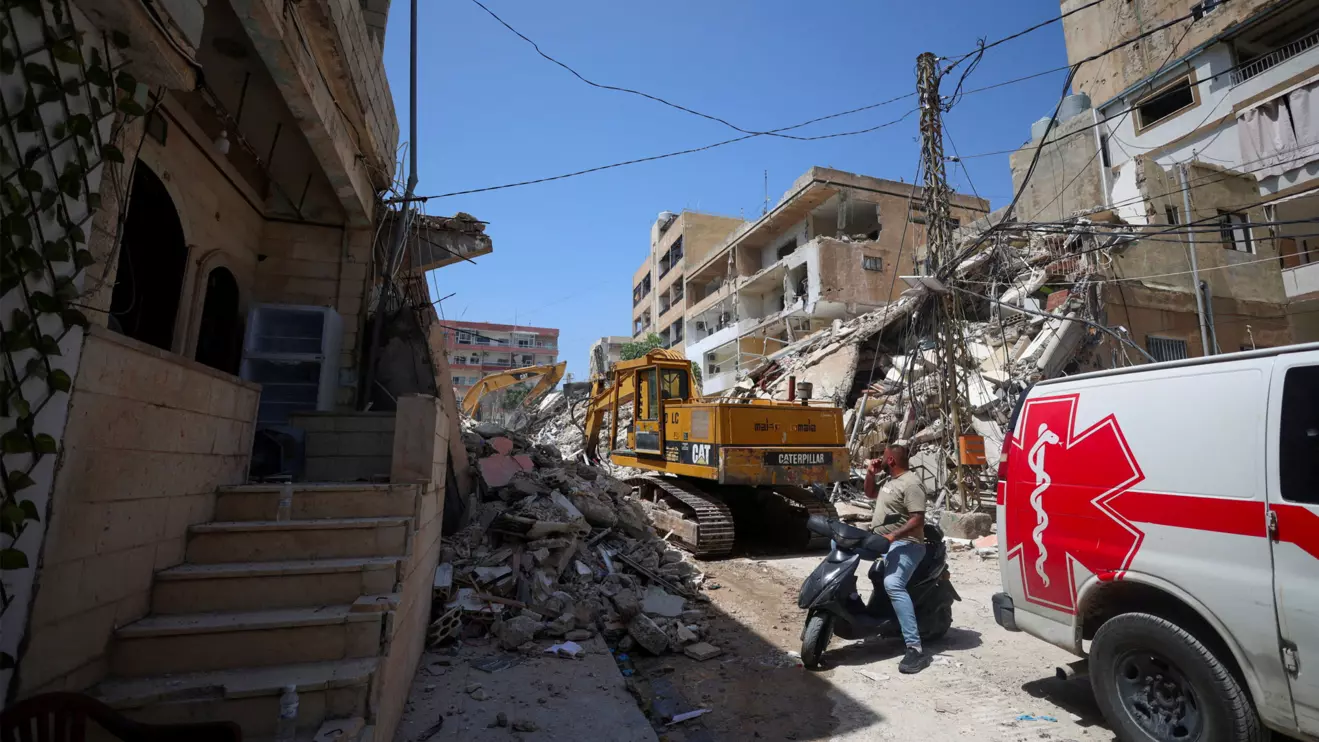 A man next to an ambulance looks at the site of an Israeli strike carried out before a 10-day ceasefire between Lebanon and Israel went into effect, in Tyre, Lebanon, April 17, 2026. Reuters/Louisa Gouliamaki