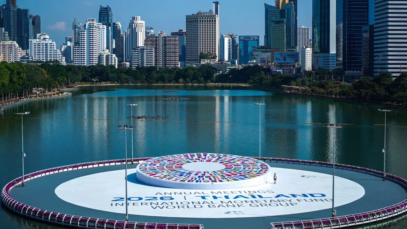 A man walks next to the logo of the 2026 IMF-World Bank Annual Meetings, ahead of the meeting at Queen Sirikit National Convention Center (QSNCC), in Bangkok, Thailand, October 9, 2026. Reuters/Athit Perawongmetha