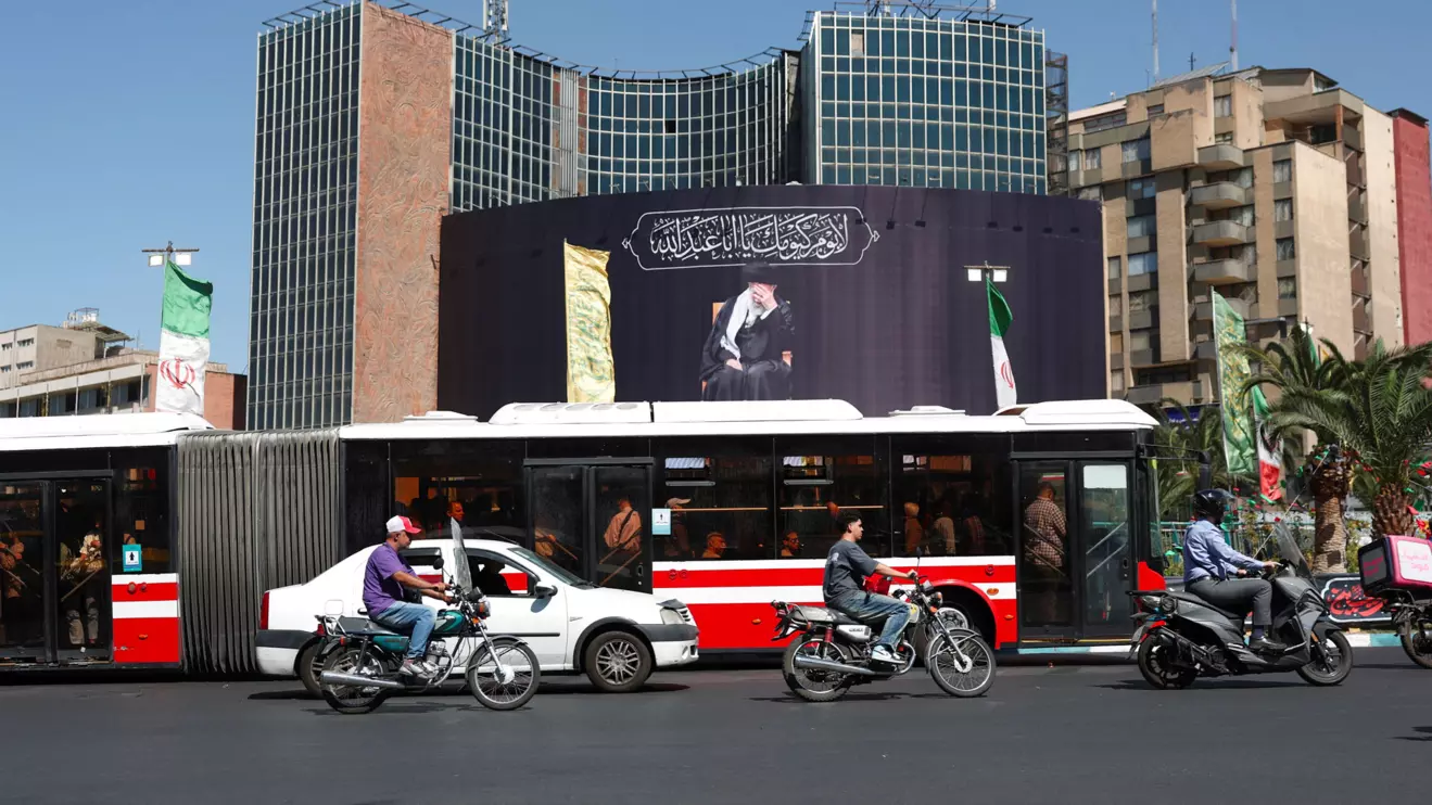 People drive past a billboard with a picture of the late Iran's Supreme Leader Ayatollah Ali Khamenei, after U.S. and Iranian officials said they had reached a deal to end their war and reopen the Strait of Hormuz, in Tehran, Iran, June 15, 2026. Majid Asgaripour/WANA (West Asia News Agency) via Reuters