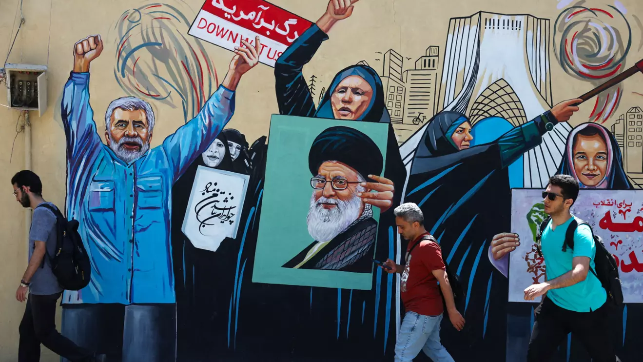People walk on a street near a mural featuring an image of the late Supreme Leader of Iran, Ayatollah Ali Khamenei, in Tehran, Iran, May 11, 2026. Majid Asgaripour/WANA (West Asia News Agency) via Reuters 
