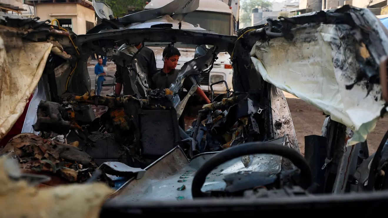 Palestinians inspect a car hit in an Israeli strike on Monday, in Gaza City, July 8, 2025. Reuters/Mahmoud Issa
