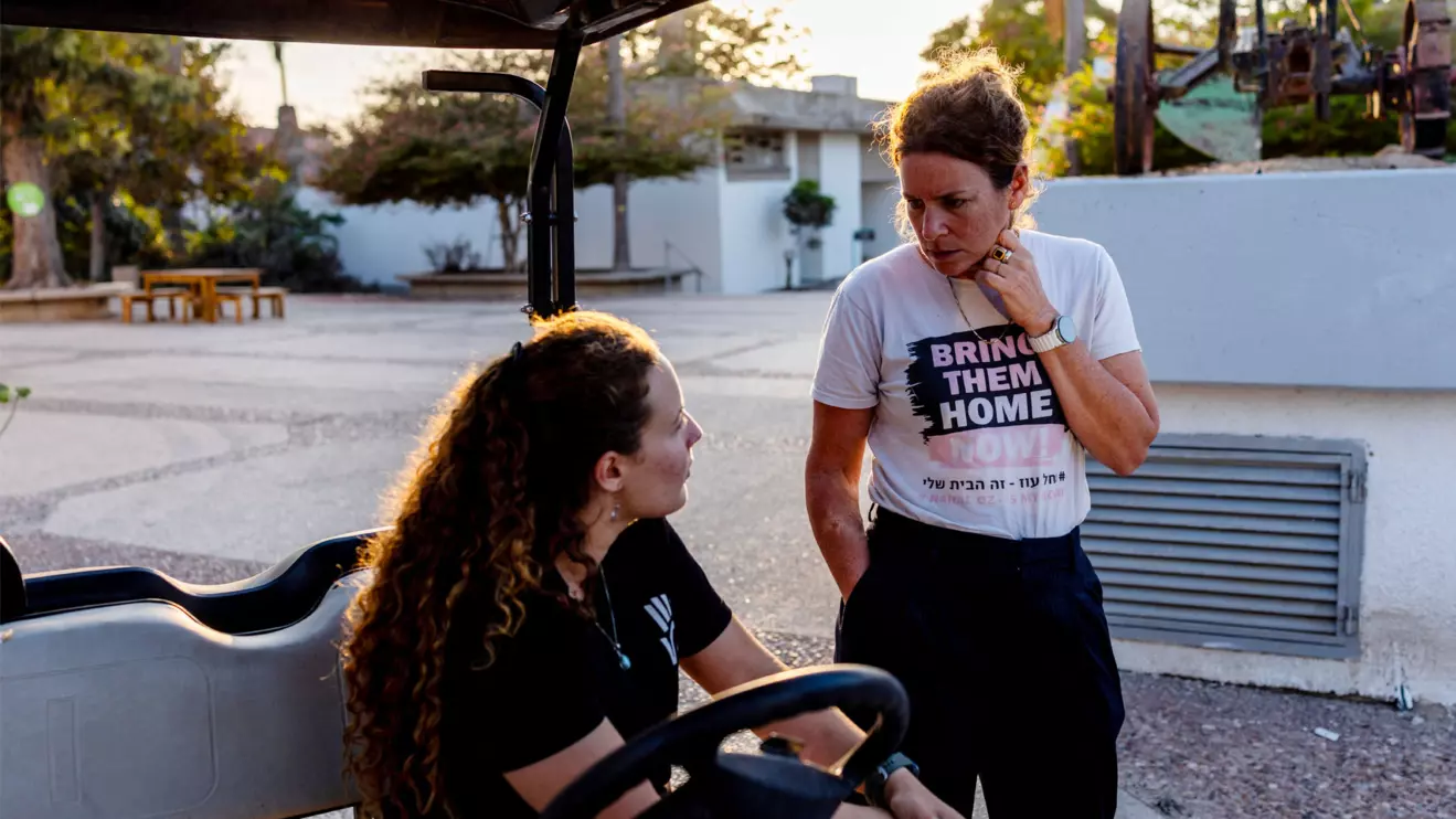 Kibbutz member Yael Raz Lachyani, 49, speaks with a volunteer in Kibbutz Nahal Oz in southern Israel, October 28, 2025. Hamas gunmen killed 15 people from Nahal Oz and took eight more hostage to Gaza on October 7, 2023. Reuters/Ronen Zvulun
