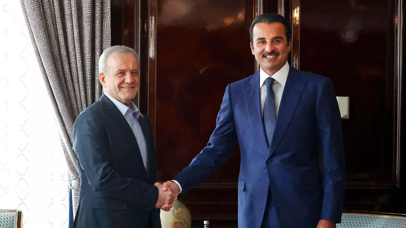 Iranian President Masoud Pezeshkian shakes hands with Qatar's Emir Sheikh Tamim bin Hamad Al Thani as they meet in Moscow, Russia, October 27, 2026. Iran's Presidential website/WANA (West Asia News Agency)/Handout via Reuters