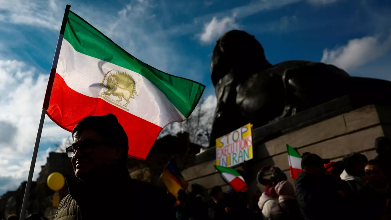 A man holds a flag during a protest by supporters of Iranian opposition group National Council of Resistance of Iran (NCRI), against the nuclear program and the detention of EU nationals as tensions escalate between France and Iran, in Paris, France, February 8, 2025. ReutersGonzalo Fuentes