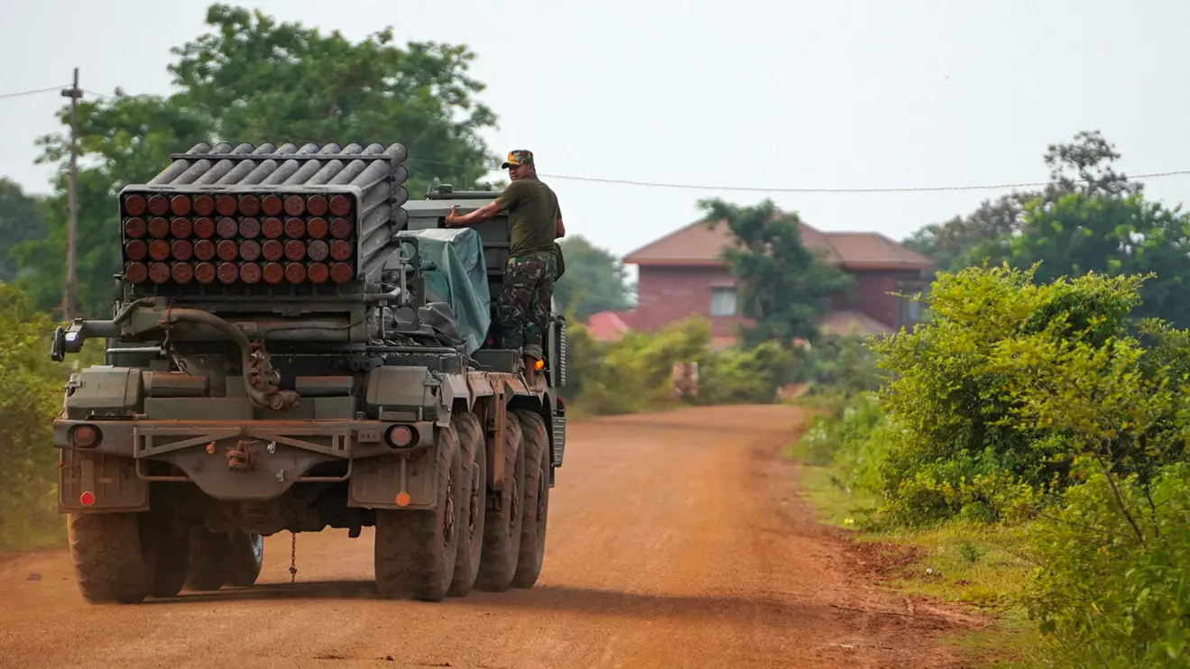 A Cambodian military personnel stands on a BM-21 Grad multiple rocket launcher, around 40 km (24 miles) from the disputed Ta Moan Thom temple, after Thailand and Cambodia exchanged heavy artillery on Friday as their worst fighting in more than a decade stretched for a second day, in Oddar Meanchey province, Cambodia, July 25, 2025. Reuters/Soveit Yarn