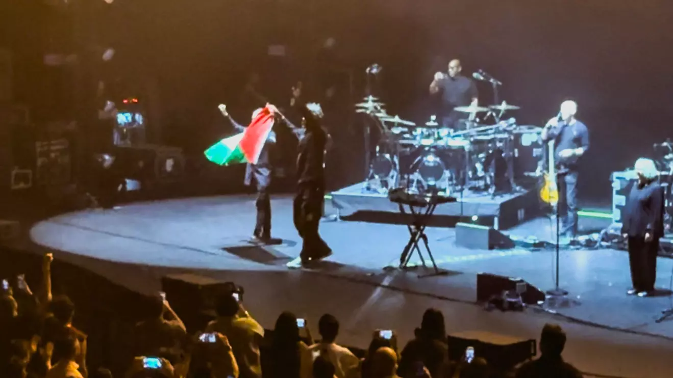 Robert Del Naja and Grant Marshall from Massive Attack stand with a Palestinian flag onstage at the end of their performance in Singapore, July 29, 2026, in this screengrab from video obtained from social media. Simran Panaech/via Reuters