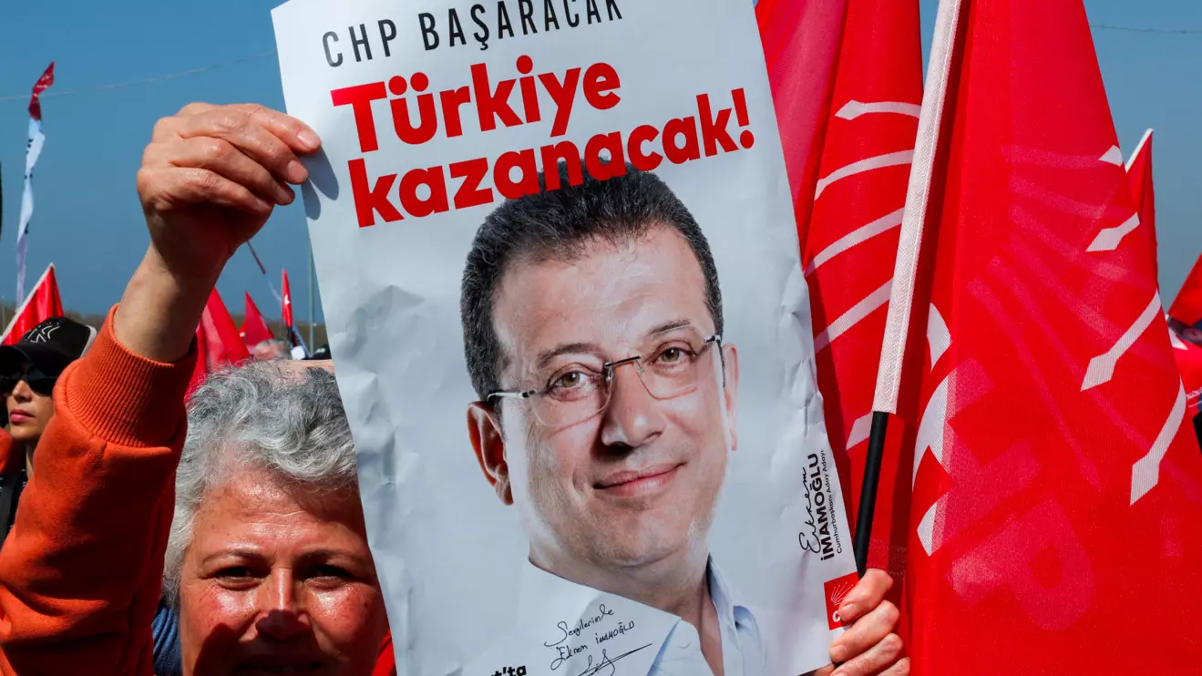 A person holds a placard during a rally to protest against the arrest of Istanbul Mayor Ekrem Imamoglu as part of a corruption investigation, in Istanbul, Turkey, March 29, 2025. ReutersS/Umit Bektas