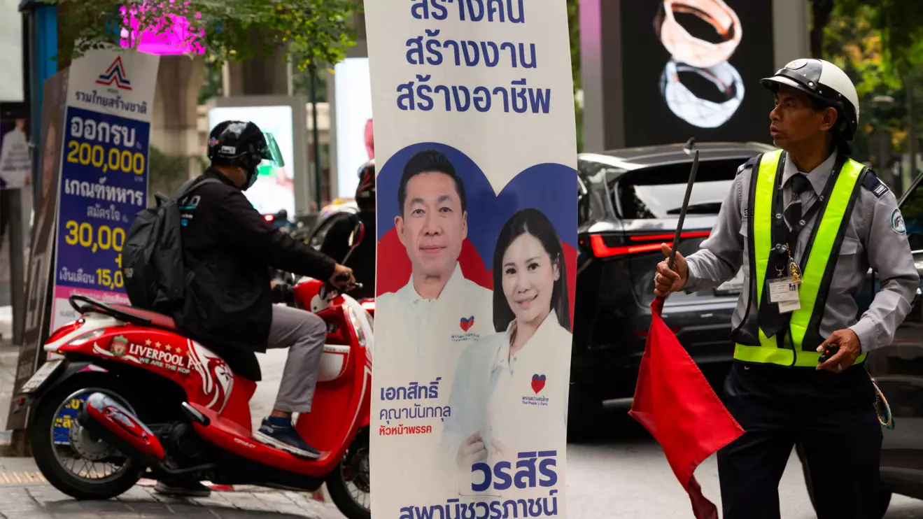 A security officer looks on next to the People's Party electoral campaign posters, before Thailand general elections on February 8, in Bangkok, Thailand, February 4, 2026. Reuters/Maxim Shemetov