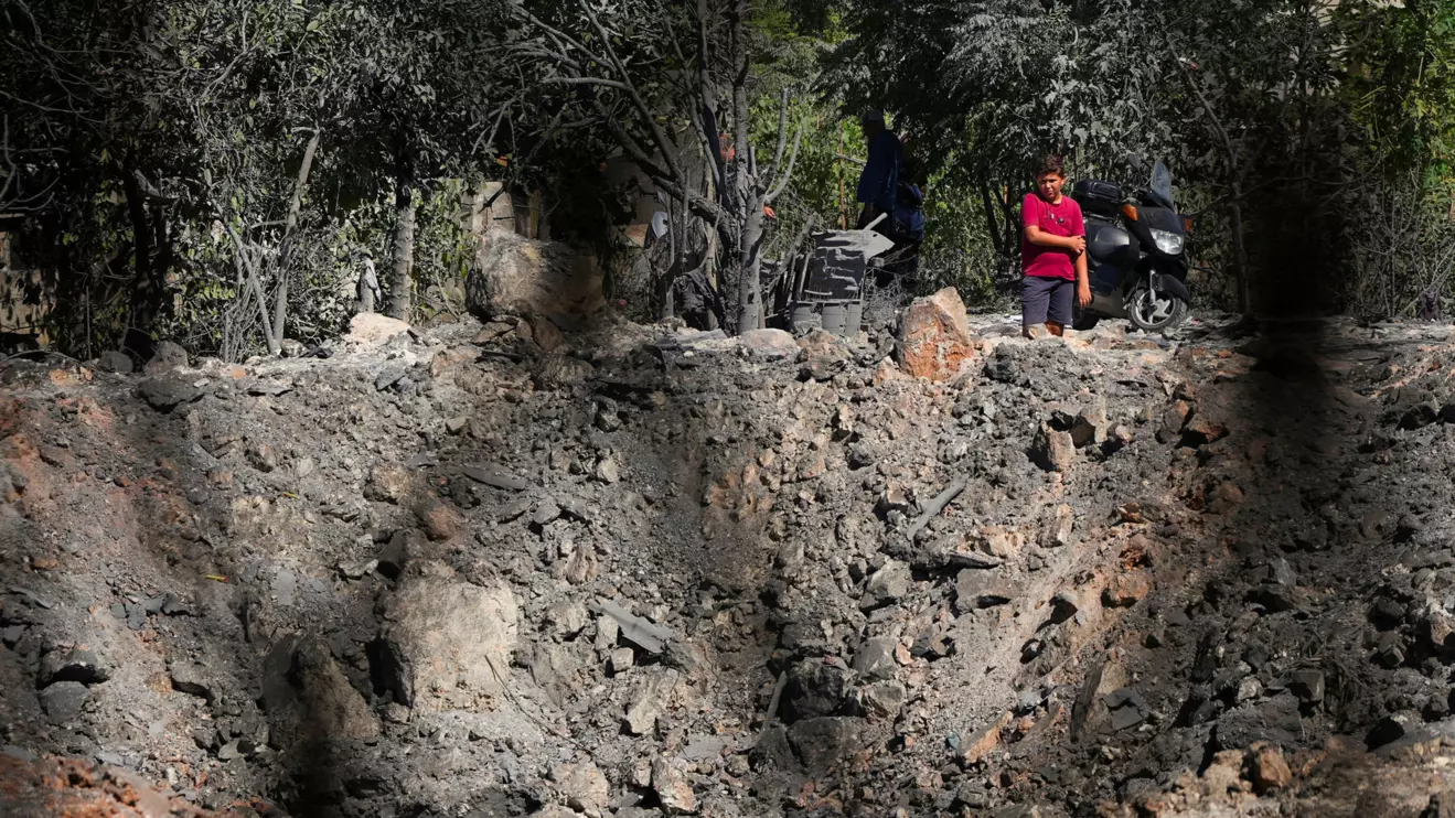People and journalists stand at a site hit by Israeli strikes that occurred in the early hours of Thursday, according to Lebanon’s state news agency NNA, in Burj al-Shamali, southern Lebanon, August 6, 2026. Reuters