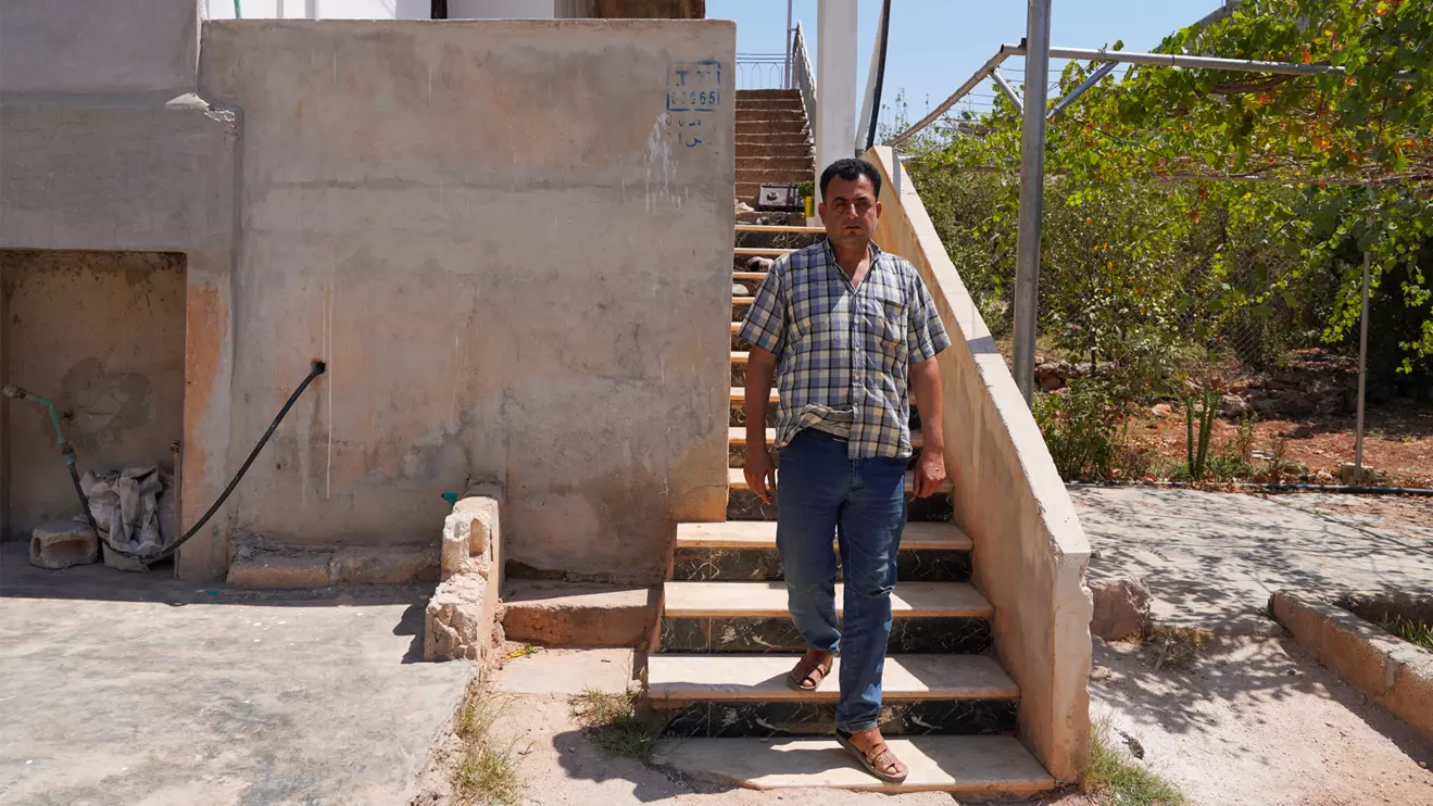 Abdelqader al-Sheikh, a neighbor who lives near the building, where according to Syrian security forces and residents, U.S. forces took part in a pre-dawn raid that targeted a member of the Islamic State group, a U.S. official and a Syrian security source said, walks outside his house, in Atmeh, Syria, August 20, 2025. Reuters/Karam al-Masri