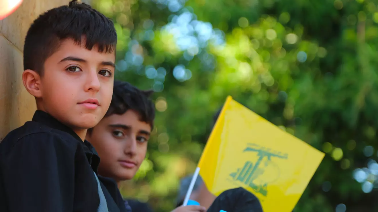 Tyre city-Lebanon A boy carrying the yellow Hezbollah flag © Mena Today 