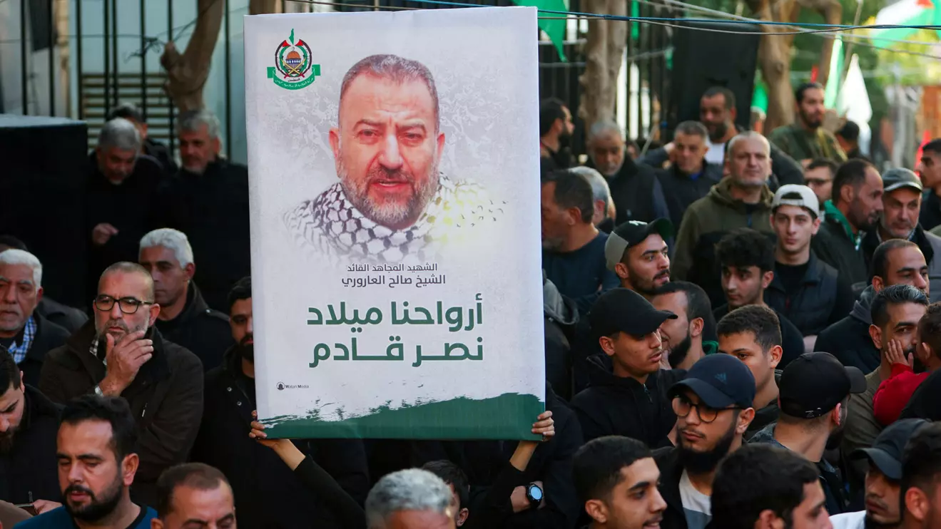 A person holds a placard displaying the photo of late Hamas deputy leader Saleh al-Arouri during the funeral of Ahmad Hammoud, who was killed along with al-Arouri of what security sources said was an Israeli drone strike in Beirut on Tuesday, in Burj al-Shemali in Tyre, Lebanon, January 3, 2024. ReutersAziz Taher