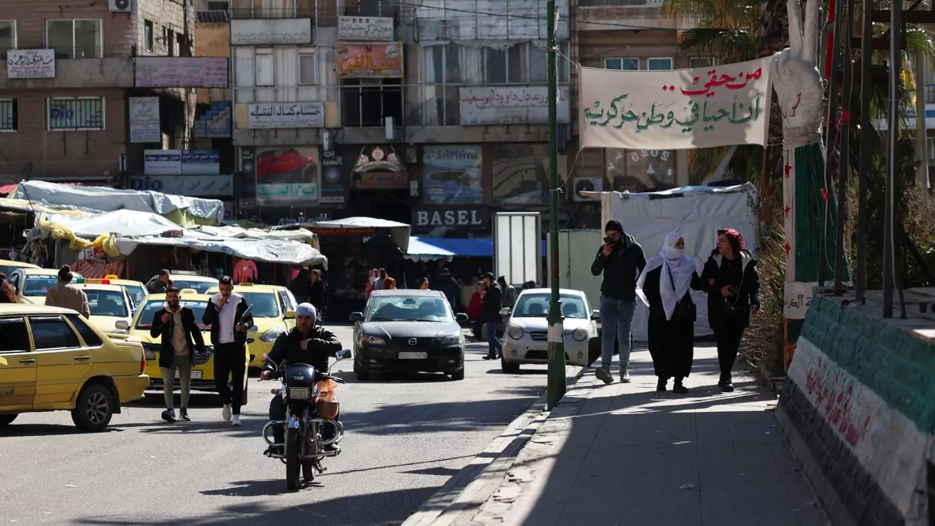 Cars drive and people walk along a street in Sweida, Syria February 25, 2025. Reuters/Yamam al Shaar