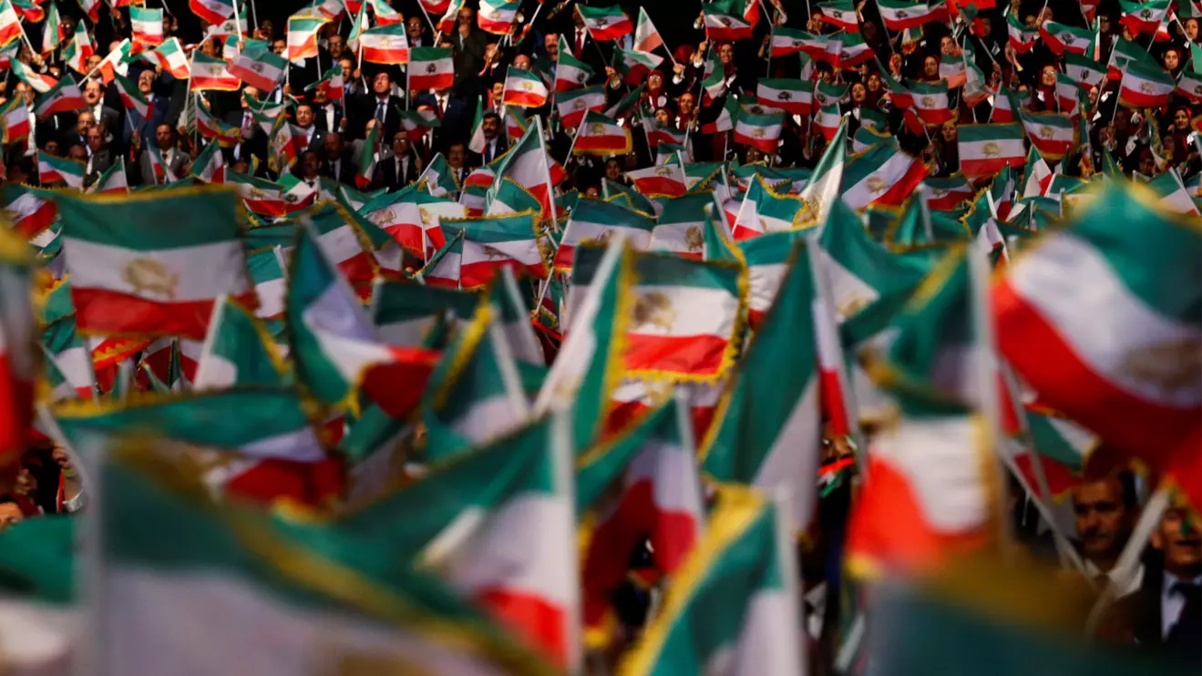 People wave flags during at an event in Ashraf-3 camp, which is a base for the People's Mojahedin Organization of Iran (MEK) in Manza, Albania, July 13, 2019.Reuters/Florion Goga