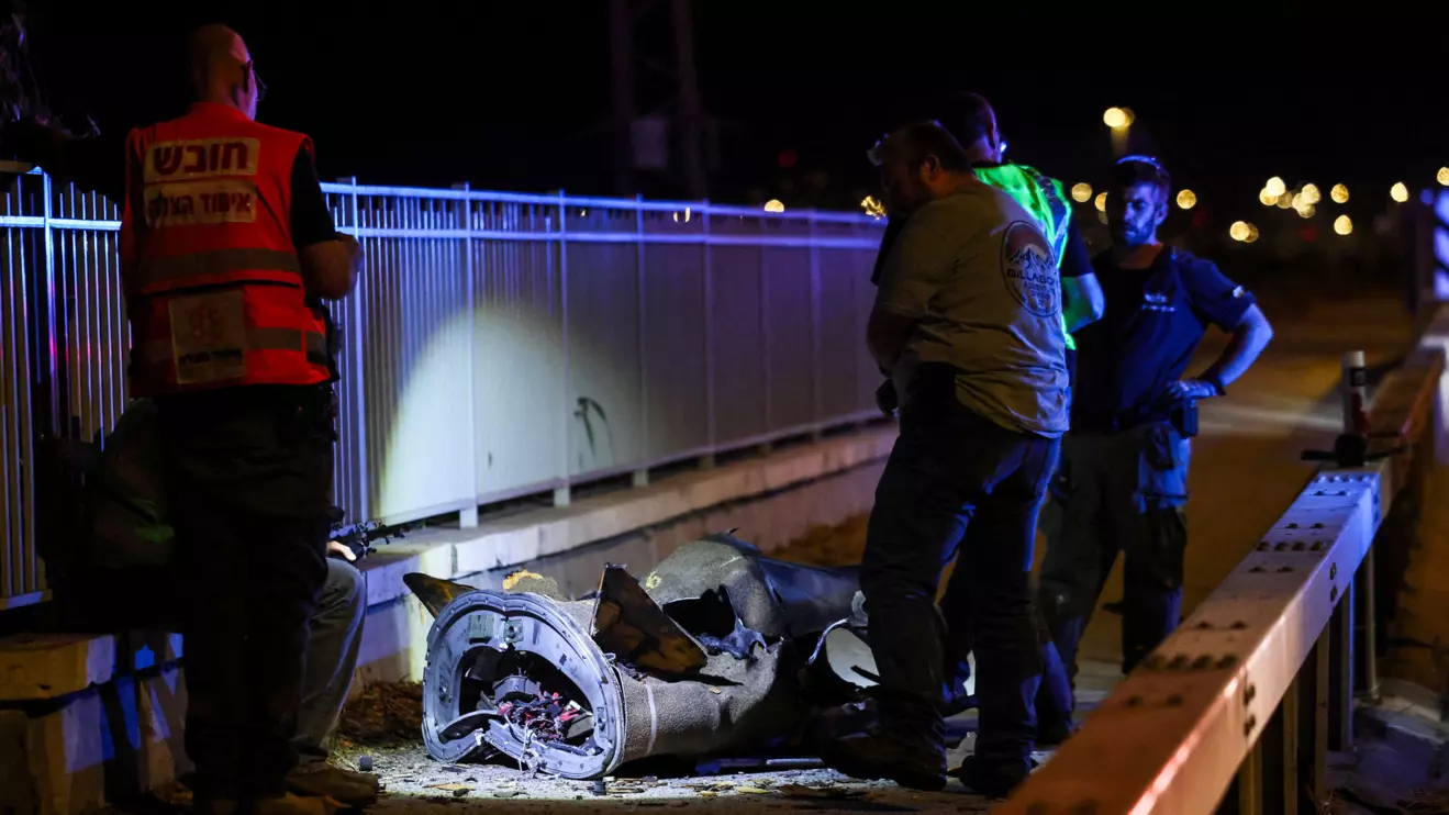 Israeli security and rescue personnel work next to a part of a projectile following a missile attack from Iran towards Israel in northern Israel, June 8, 2026. Reuters/Shir Torem