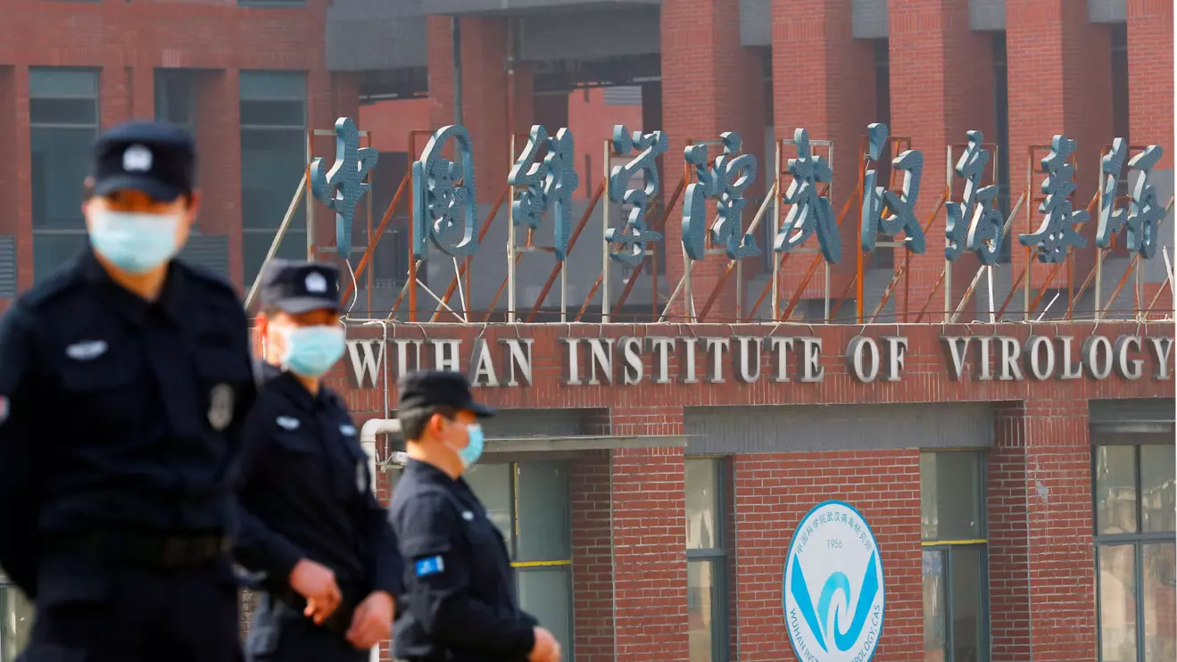 Security personnel keep watch outside the Wuhan Institute of Virology during the visit by the World Health Organization (WHO) team tasked with investigating the origins of the coronavirus disease (COVID-19), in Wuhan, Hubei province, China February 3, 2021. Reuters/Thomas Peter