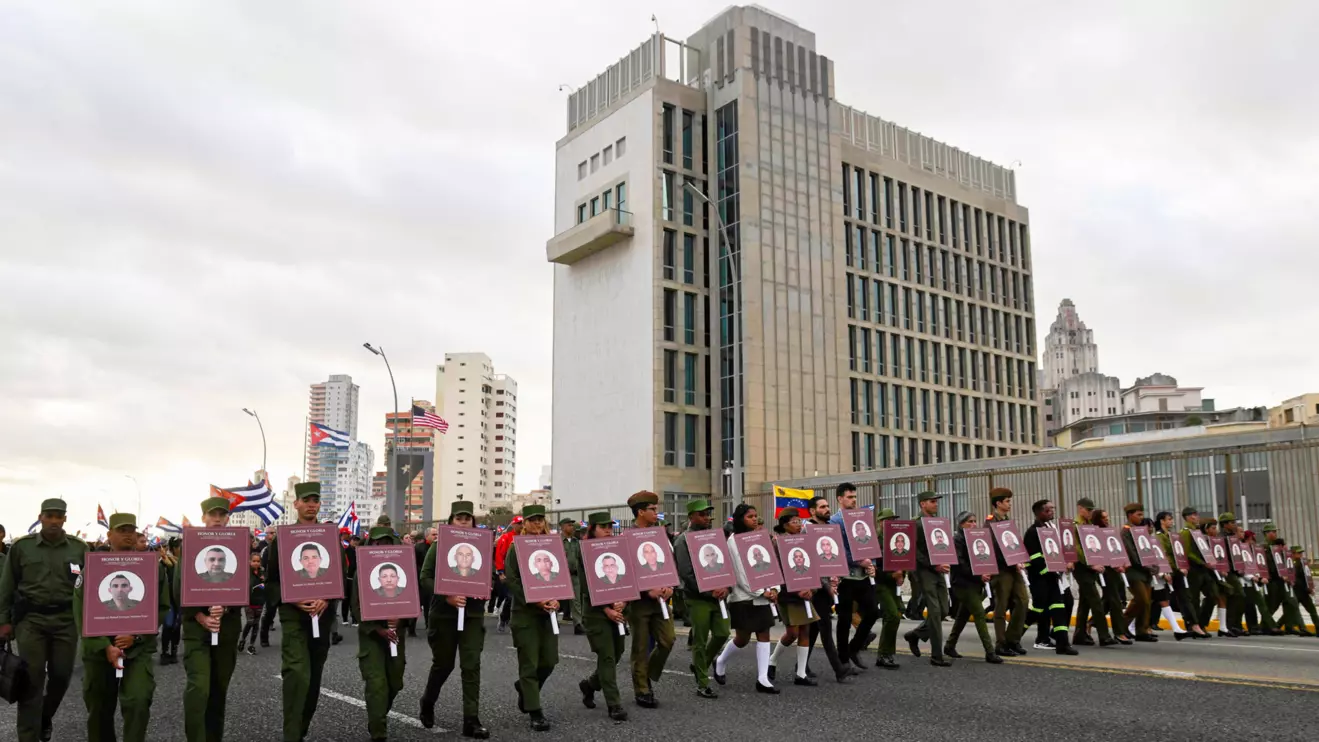 Cuban military personnel carry portraits of soldiers killed in the U.S. strike on Venezuela and the U.S. capture of President Nicolas Maduro and his wife, Cilia Flores, during a march outside the U.S. Embassy to protest against what they denounce as U.S. aggression in the region, in Havana, Cuba, January 16, 2026. Reuters/Norlys Perez