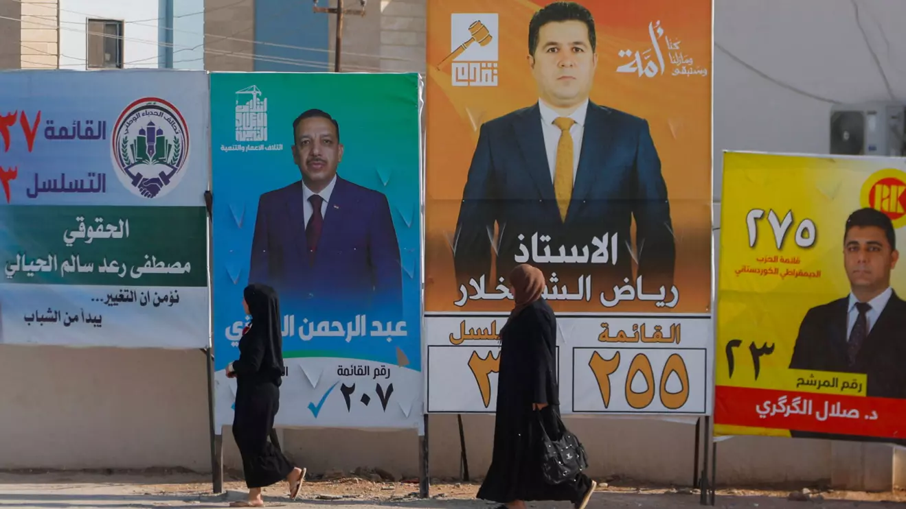 Women walk past campaign posters of candidates ahead of Iraq’s upcoming parliamentary elections in Mosul, Iraq, November 6, 2025. Reuters/Khalid al-Mousily