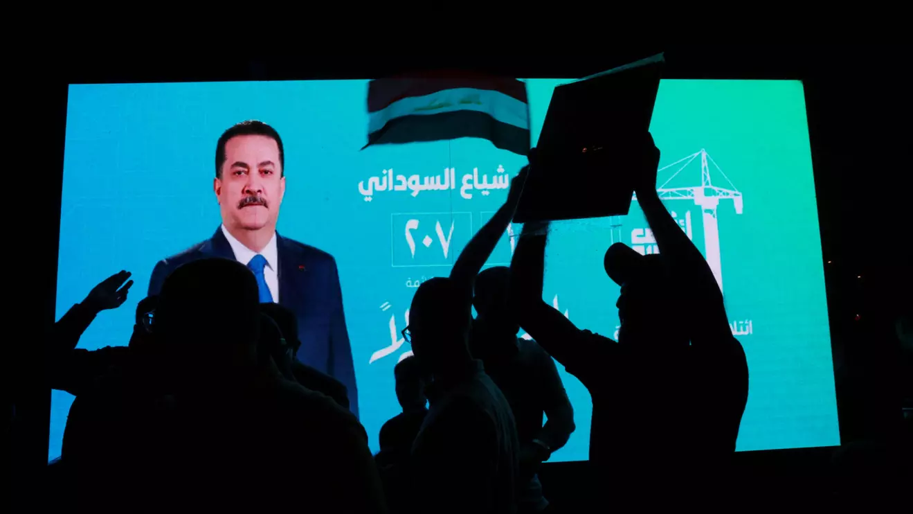 A screen with an election poster featuring current Prime Minister Mohammed Shia' al-Sudani is seen as supporters of the Reconstruction and Development Coalition celebrate after preliminary election results were announced in Baghdad, Iraq, November 12, 2025. Reuters/Ahmed Saad