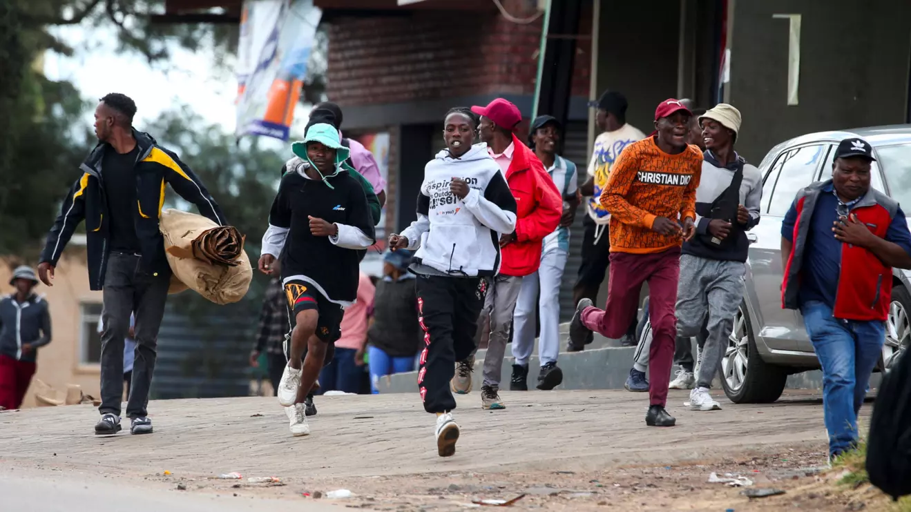 People run as anti-riot police officers clash with protesters in the capital Harare, Zimbabwe, March 31, 2025.Reuters/Philimon Bulawayo