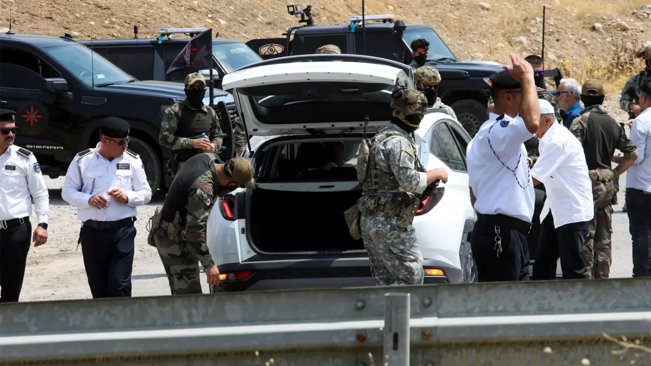 A vehicle is inspected at a checkpoint, on the day of a disarmament ceremony of Kurdistan Workers' Party (PKK) fighters, marking a significant step toward ending the decades-long conflict between Turkey and the outlawed group, near Sulaymaniyah, Iraq, July 11, 2025. Reuters/Ako Rasheed