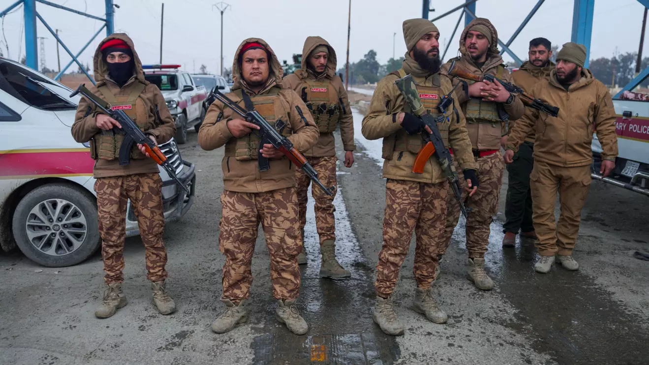Members of the Syrian military police gather outside al-Aqtan prison, where some Islamic State detainees are held, in Raqqa, Syria January 22, 2026. Reuters/Karam al-Masri