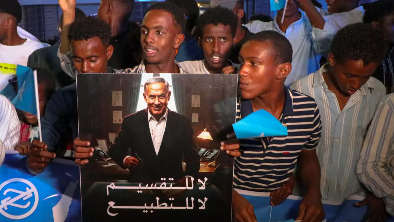 A demonstrator holds an image depicting Israeli Prime Minister Benjamin Netanyahu as Somalis attend a demonstration after Israel became the first country to formally recognise the self-declared Republic of Somaliland as an independent and sovereign state, Mogadishu, Somalia, December 28, 2025. Reuters/Feisal O