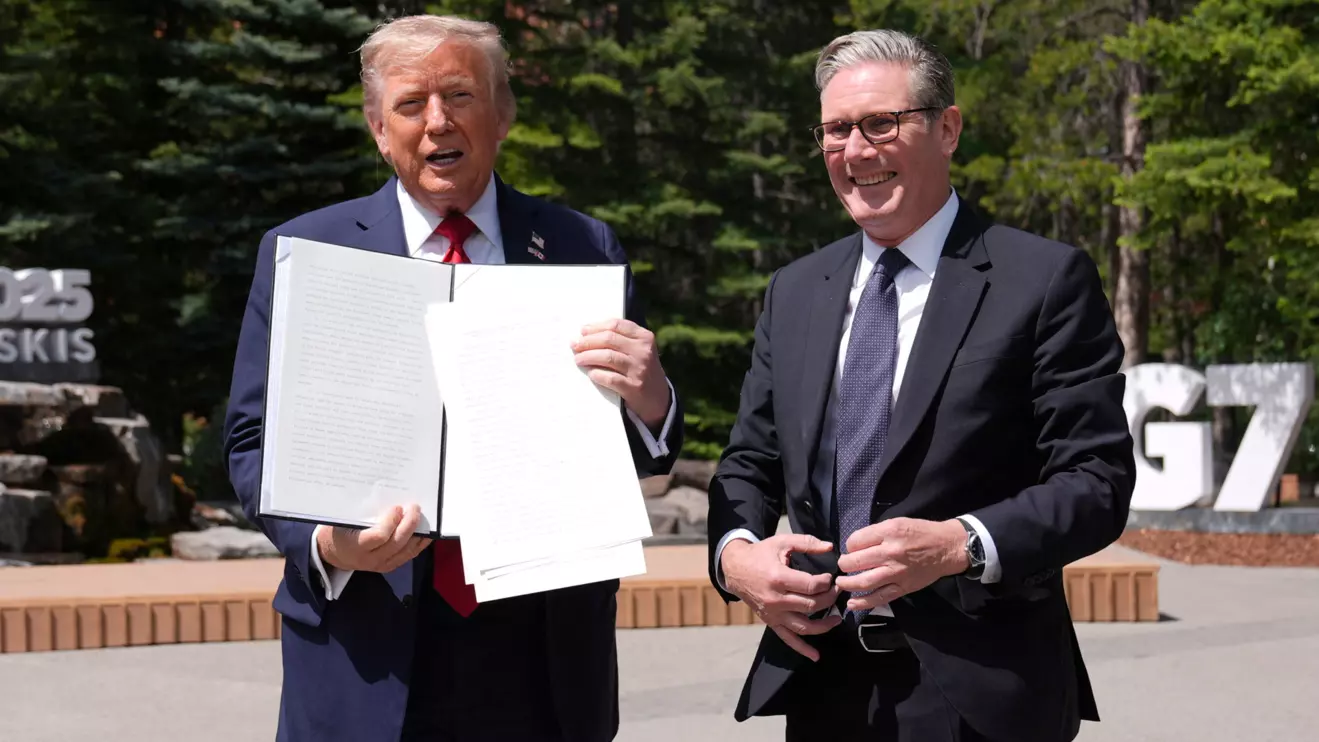 U.S. President Donald Trump holds a signed Trade Agreement with Britain during a meeting with British Prime Minister Keir Starmer, at the G7 summit, in Kananaskis, Alberta, Canada June 16, 2025. Stefan Rousseau/Reuters