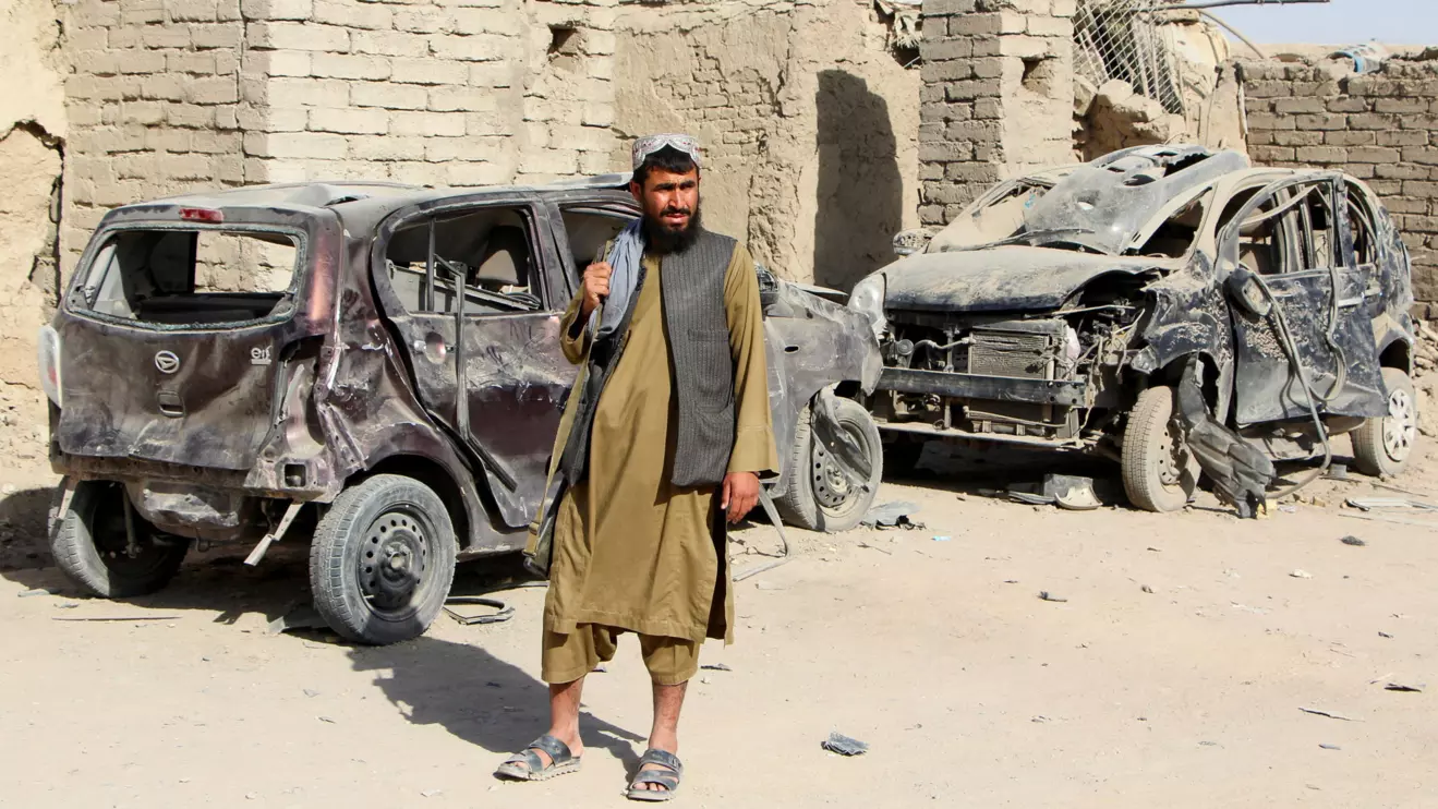 A Taliban fighter stands next to vehicles destroyed during an airstrike, following a temporary ceasefire, amid the conflict between Afghanistan and Pakistan, in Spin Boldak district of Kandahar Province, Afghanistan, October 16, 2025. Reuters